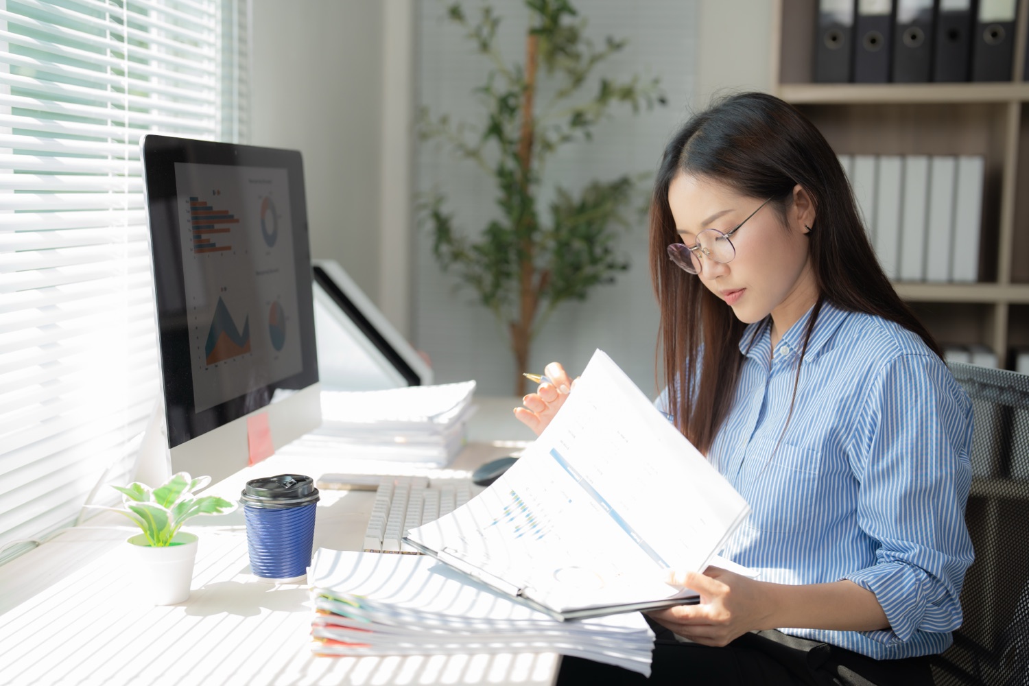 Business owner reviewing accounts receivable and cash-flow reports